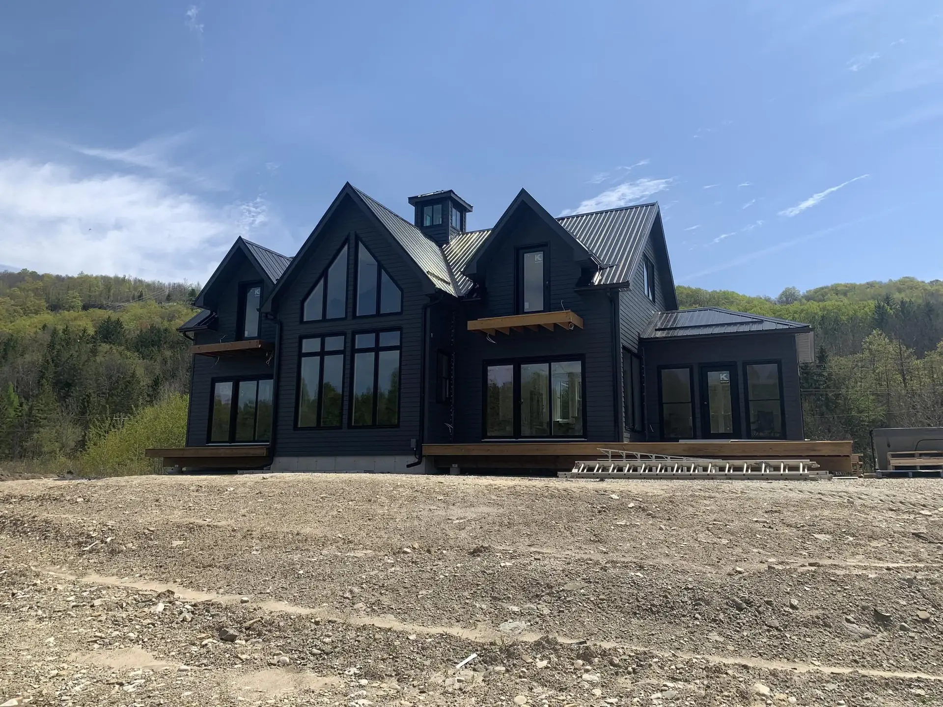 Modern black custom home with steel roof built by CKThompson Contracting in Grey County