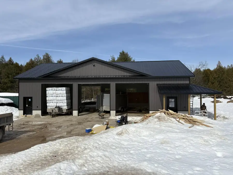 Steel clad shop with large overhead doors
